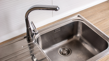 Chrome kitchen sink with faucet