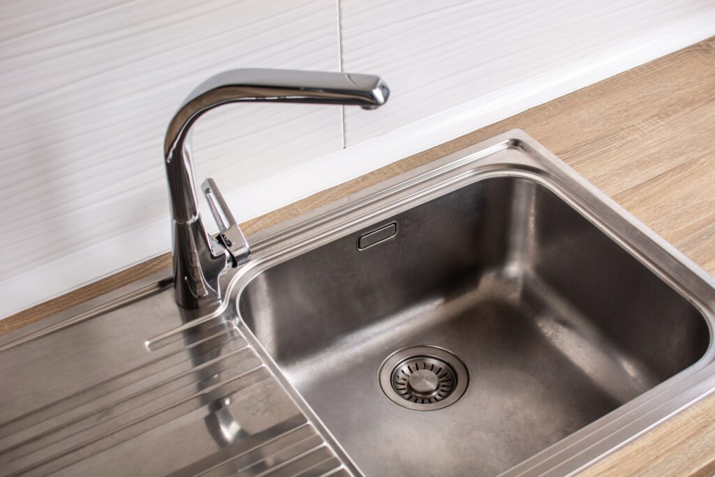 Chrome kitchen sink with faucet